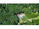 Aerial shot of a house nestled among dense trees, offering privacy and a connection with nature at 1216 Oleander Sw Dr, Lilburn, GA 30047