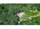 Aerial view of a house nestled among lush green trees, offering privacy and a serene, natural setting at 1216 Oleander Sw Dr, Lilburn, GA 30047