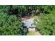 A home surrounded by dense trees with a paved patio and lush landscaping at 1216 Oleander Sw Dr, Lilburn, GA 30047