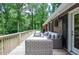 View of the spacious back porch with beautiful wooded scenery beyond at 1216 Oleander Sw Dr, Lilburn, GA 30047