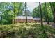 Backyard view showcasing a large deck, perfect for outdoor entertaining in a private wooded setting at 1216 Oleander Sw Dr, Lilburn, GA 30047