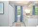 Bright bathroom featuring a double vanity with granite countertop and blue curtains at 1216 Oleander Sw Dr, Lilburn, GA 30047