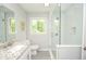 Modern bathroom with glass-enclosed shower, gray tile, and a stylish granite vanity at 1216 Oleander Sw Dr, Lilburn, GA 30047