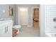 Bathroom view showcasing toilet, shower and doorways to closet and other rooms at 1216 Oleander Sw Dr, Lilburn, GA 30047