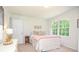 Bright bedroom with neutral walls, large windows, and a comfortable bed with stylish bedding at 1216 Oleander Sw Dr, Lilburn, GA 30047