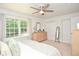 Inviting bedroom with neutral decor, carpeted floors, and an abundance of natural light from the expansive windows at 1216 Oleander Sw Dr, Lilburn, GA 30047