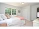 Bright bedroom with neutral walls, a window with natural light, and a comfortable bed at 1216 Oleander Sw Dr, Lilburn, GA 30047