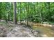 Scenic creek view with a rocky shoreline and clear water, enhancing the property's natural appeal at 1216 Oleander Sw Dr, Lilburn, GA 30047