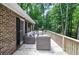 Charming deck with outdoor seating and a view of the surrounding trees at 1216 Oleander Sw Dr, Lilburn, GA 30047