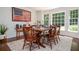 Comfortable dining area with hardwood floors, natural light, and a classic wood table at 1216 Oleander Sw Dr, Lilburn, GA 30047