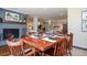 Dining room featuring a wood table set for six and painted brick fireplace at 1216 Oleander Sw Dr, Lilburn, GA 30047