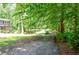 Long driveway leading to the home, surrounded by mature trees and lush lawn at 1216 Oleander Sw Dr, Lilburn, GA 30047
