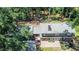 Aerial view of a two-story brick house with a paved patio and lush landscaping at 1216 Oleander Sw Dr, Lilburn, GA 30047