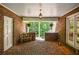 Inviting covered brick porch with welcome mat, bench and exterior lighting at 1216 Oleander Sw Dr, Lilburn, GA 30047
