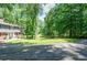 Charming two-story home with brick accents and a well manicured lawn with gravel driveway at 1216 Oleander Sw Dr, Lilburn, GA 30047