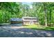 Charming two-story home with brick accents and a lush green lawn surrounded by mature trees at 1216 Oleander Sw Dr, Lilburn, GA 30047