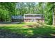 Charming two-story home with brick accents and a lush green lawn surrounded by mature trees at 1216 Oleander Sw Dr, Lilburn, GA 30047