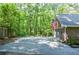 Garage and parking area, next to wooded area and the American flag is displayed on the house at 1216 Oleander Sw Dr, Lilburn, GA 30047