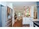 Open concept kitchen with stainless steel refrigerator, granite countertops, and view into the living room at 1216 Oleander Sw Dr, Lilburn, GA 30047
