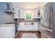 Beautiful kitchen featuring stainless steel appliances, white cabinetry, granite countertops, and a stylish tile backsplash at 1216 Oleander Sw Dr, Lilburn, GA 30047