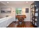 Bright room with hardwood floors, a bookshelf, and a view to the outdoors at 1216 Oleander Sw Dr, Lilburn, GA 30047