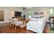 Bright living room with hardwood floors, a TV, and a comfortable white sofa for relaxation at 1216 Oleander Sw Dr, Lilburn, GA 30047