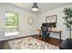 Bright home office with a standing desk, two monitors, and a large window for natural light and backyard views at 1216 Oleander Sw Dr, Lilburn, GA 30047