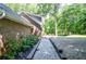 Exterior view showing the side yard with landscaped garden beds and a charming gravel path at 1216 Oleander Sw Dr, Lilburn, GA 30047
