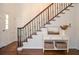 Beautiful staircase with dark wood steps, iron railings, and console table with decor near the front door at 1216 Oleander Sw Dr, Lilburn, GA 30047