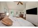 Primary bedroom featuring vaulted ceiling, hardwood floors, and a television at 132 East Ne Dr, Atlanta, GA 30305