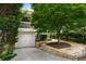 This home features a beautiful landscaped front yard, a garage, and a second story balcony at 132 East Ne Dr, Atlanta, GA 30305
