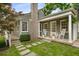 Charming home exterior featuring a stone chimney and inviting front porch with rocking chairs at 132 East Ne Dr, Atlanta, GA 30305