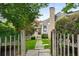 Inviting home exterior with a stone chimney, stepping stone pathway, and a charming picket fence at 132 East Ne Dr, Atlanta, GA 30305