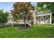 Charming home with a well-manicured lawn, mature tree, and a cozy front porch with rocking chairs at 132 East Ne Dr, Atlanta, GA 30305