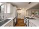 Well-lit kitchen with stainless steel appliances, white cabinets, and quartz countertops at 132 East Ne Dr, Atlanta, GA 30305
