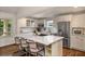 Modern kitchen with quartz countertop island, stainless steel appliances, and white cabinets at 132 East Ne Dr, Atlanta, GA 30305