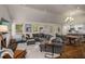 Bright living room featuring a fireplace, vaulted ceiling, hardwood floors, and a comfortable grey sectional sofa at 132 East Ne Dr, Atlanta, GA 30305
