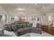 Open-concept living room with grey sectional sofa, vaulted ceiling, and view of the modern kitchen at 132 East Ne Dr, Atlanta, GA 30305