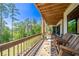 Relaxing back porch with rocking chairs and a scenic view, ideal for enjoying nature and quiet moments at 23 Sunset Se Rdg, Cartersville, GA 30121