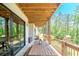 Covered back porch featuring a wooden table set, with an outdoor play structure visible in the background at 23 Sunset Se Rdg, Cartersville, GA 30121
