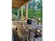 Relaxing back porch with rustic wooden furniture and decorative bear statue, providing a cozy outdoor retreat at 23 Sunset Se Rdg, Cartersville, GA 30121