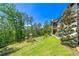 Expansive backyard featuring a well-maintained lawn, and a wooden playset, perfect for outdoor activities at 23 Sunset Se Rdg, Cartersville, GA 30121