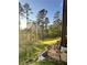 An expansive backyard with lush green grass, bordered by a wood fence and a stone paver pathway at 23 Sunset Se Rdg, Cartersville, GA 30121
