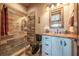 Rustic bathroom featuring a wood-look tile shower and a copper sink with wood countertop at 23 Sunset Se Rdg, Cartersville, GA 30121