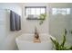 Bright bathroom features a soaking tub, chrome fixtures, a dark wood shelf, and a window at 23 Sunset Se Rdg, Cartersville, GA 30121
