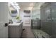 Bright bathroom featuring a vessel sink, modern vanity, and frameless glass shower with gray subway tile and stone pebble flooring at 23 Sunset Se Rdg, Cartersville, GA 30121