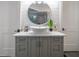 Bathroom features a sleek vessel sink with a large round mirror, marble countertop, and stylish gray vanity with contemporary hardware at 23 Sunset Se Rdg, Cartersville, GA 30121