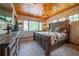 Bedroom with brick walls, wood chandelier, and a large bed at 23 Sunset Se Rdg, Cartersville, GA 30121