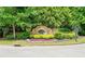 Community entrance sign amidst lush landscaping and colorful flower beds at 23 Sunset Se Rdg, Cartersville, GA 30121