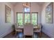 Elegant dining room with modern chandelier, dark wood floors, and large windows with scenic views at 23 Sunset Se Rdg, Cartersville, GA 30121